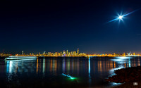 Full moon over Seattle with water taxi and diver